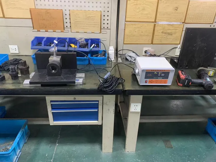 An electric torque wrench connected to a torque indicator An electric torque wrench connected to a torque indicator